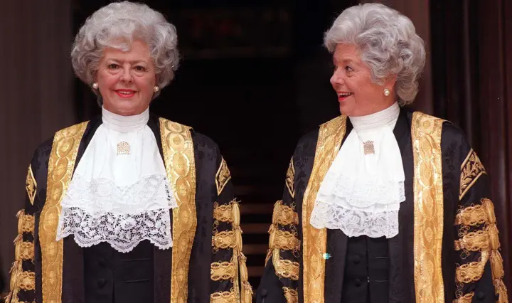 Colour photo showing Boothroyd in her Speaker's robes looking sideways at her waxwork dressed in identical clothes